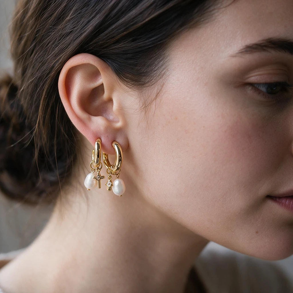 Close-up of both charm hoop earrings worn together in a stacked ear piercing